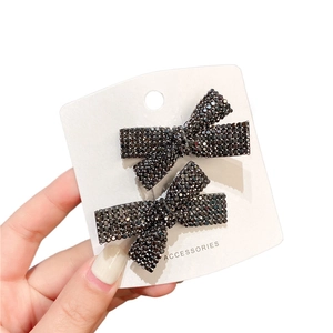 Set of two black rhinestone bow hair clips with a full sparkling crystal design for women