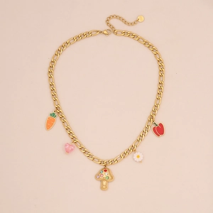 Detail of gold necklace with carrot, mushroom, heart, daisy, and chili pepper charms