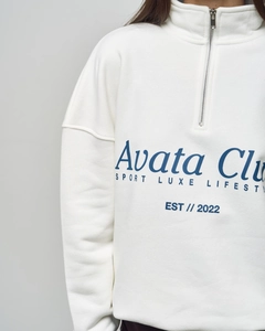 Detail of white half-zip sweatshirt with blue letter print and Est 2022 logo text