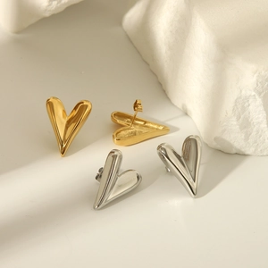 Elegant gold and silver heart-shaped titanium steel stud earrings on a stone base