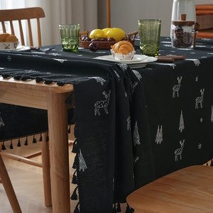 Black Christmas tablecloth with white reindeer embroidery and festive tassel edges