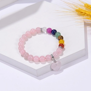 Natural 8mm rose quartz beaded bracelet with chakra stones and heart pendant on stone base