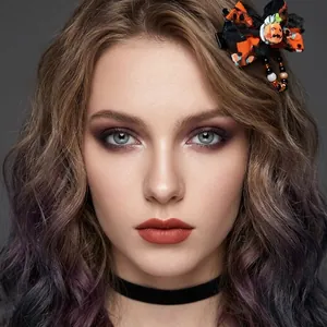 Close-up of kids Halloween pumpkin hair clip and cartoon facial stickers makeup effect
