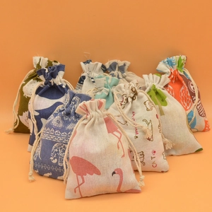 Detail of printed cotton linen drawstring gift pouches with diverse animal patterns