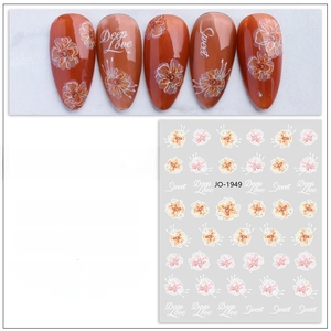 Detail of ultra-thin waterproof nail stickers with orange flowers and Sweet typography