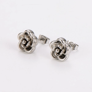 Detailed close-up of 3D rose flower earrings in silver stainless steel with vintage finish