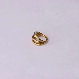 Close-up of golden triple-layered 316L stainless steel hinged segment ring for piercing