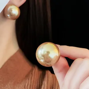 French retro oversized gold spherical stud earrings for women with metallic mirror finish