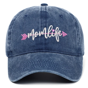 Detail of Momlife embroidery on washed navy blue denim baseball cap with pink arrow