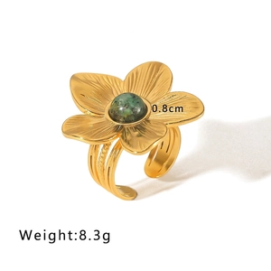 Detail of 18k gold flower ring with turquoise stone inlay and adjustable band size