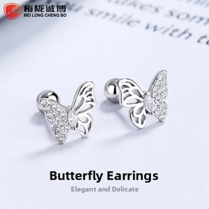 Macro detail of silver butterfly stud earrings with pave zircon and screw ball back