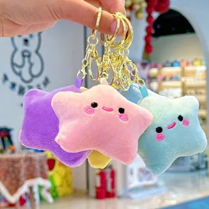 Cute plush star-shaped keychains with smiley faces in purple, pink, yellow, and cyan blue