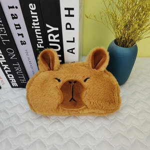 Detail of cute brown plush capybara pencil case with soft texture and embroidered features