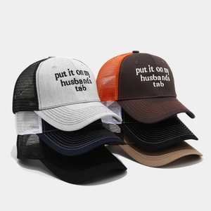 Detailed close-up of embroidered trucker hats featuring various color combinations and mesh back
