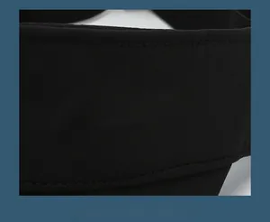 Detailed close-up of sports visor with white embossed SPORTS text on black fabric