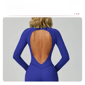 Close-up of heart-shaped open back cutout on navy blue yoga jumpsuit showing breathable fabric