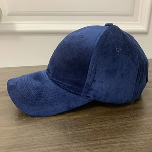 Detailed side view of dark blue velvet baseball cap showing fabric texture and seams