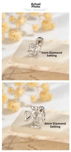 Detailed view of hollow heart four-prong earring studs in 5mm and 8mm sizes