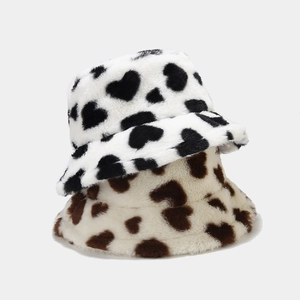 Plush heart-patterned bucket hats in black-on-white and brown-on-beige faux fur material