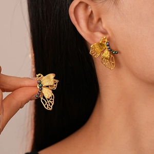 French vintage golden butterfly stud earrings with colorful beads on female model