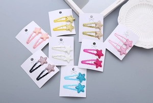Flat lay of colorful glitter star hair clips for girls in various pastel shades