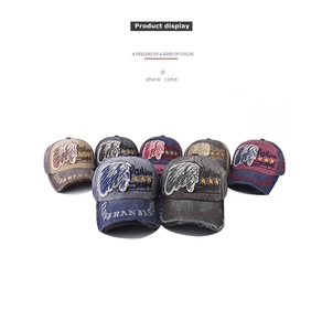 Detail of vintage washed canvas baseball caps with Indian feather embroidery in multiple colors