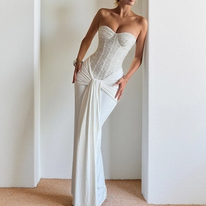 Detailed view of white sequined strapless bodice with elegant boning and draping