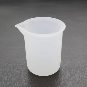 Detail showing translucent silicone measuring cup with pour spout for DIY resin art