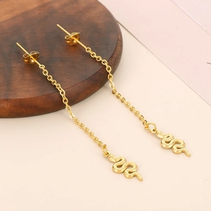 Detail view of gold snake-shaped curved relief chain earrings with long drop design