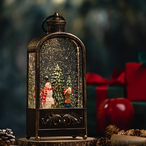 Vintage bronze Christmas lantern with snowman scene and swirling golden glitter