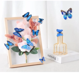 Blue 3D butterfly stickers with varied wing textures on a floral wooden frame