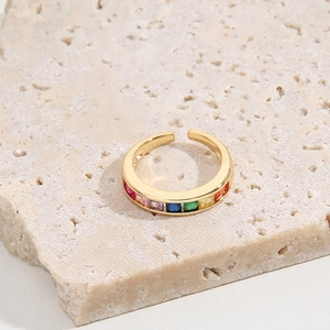 Adjustable gold ring with colorful rainbow cubic zirconia on a natural stone base