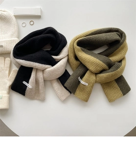 Detailed flat lay of soft ribbed knit scarves with matching hats and winter accessories