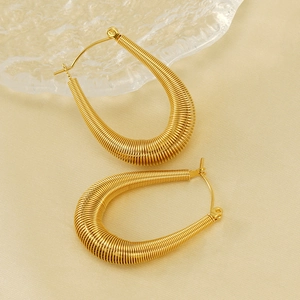 Golden U-shaped stainless steel hoop earrings with unique textured spring design for women
