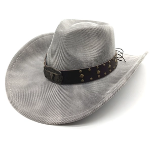 Detail of grey western cowboy hat with brown leather rivet band and bull skull metal buckle