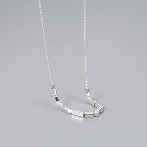Minimalist 925 sterling silver necklace with geometric cube pendants on cross chain