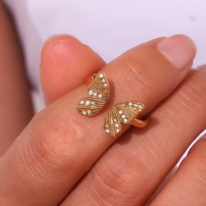 Zircon butterfly open ring in gold stainless steel shown on a hand with fine details