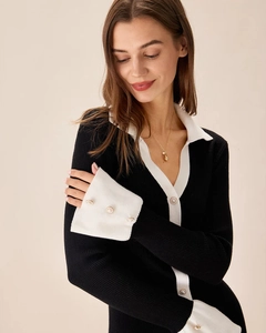 Detailed view of knitted cardigan with contrast trim and elegant pearl buttons