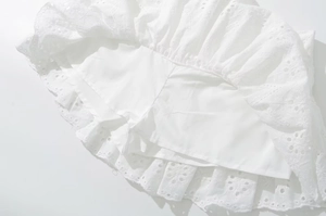 Detail of white embroidered lace skort showing the built-in safety lining shorts