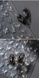 Detailed macro view of 3D iridescent butterfly and star nail art stickers on nails