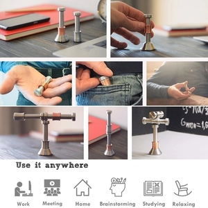 Moondrop kinetic desk toy in silver and copper metal finish shown in various usage scenarios
