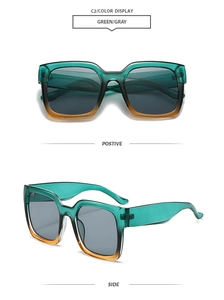 Detail view of square gradient green and orange oversized sunglasses with gray lenses