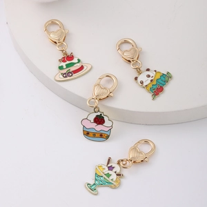 Detailed view of four colorful enamel dessert charms with gold heart-shaped lobster clasps