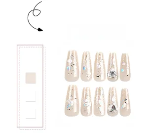 Close-up of glittery ballet press-on nails with silver sequins and 3D heart rhinestones