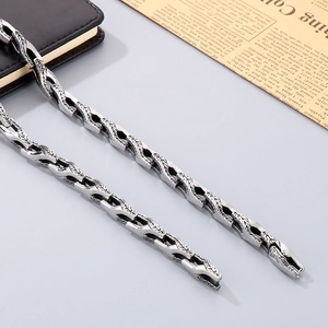 Close-up of vintage silver keel chain necklace with textured links on aesthetic background