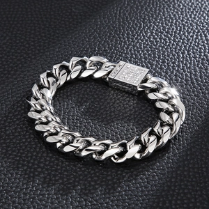 Detailed macro view of silver CNC zircon-set Cuban link bracelet on black leather background