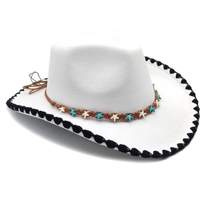 Detail of white felt cowboy hat featuring woven band with blue and white starfish decor