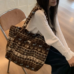 Detail of plush tote bag showing retro jacquard patterns and soft faux shearling texture