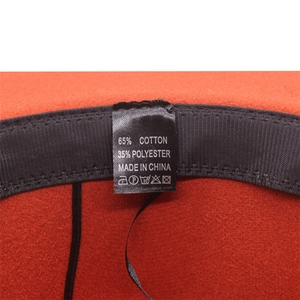 Detail of red wool felt hat interior with black sweatband and 65% cotton fabric label