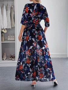 Elegant navy maxi dress with red floral print and airy chiffon fabric shown from the back